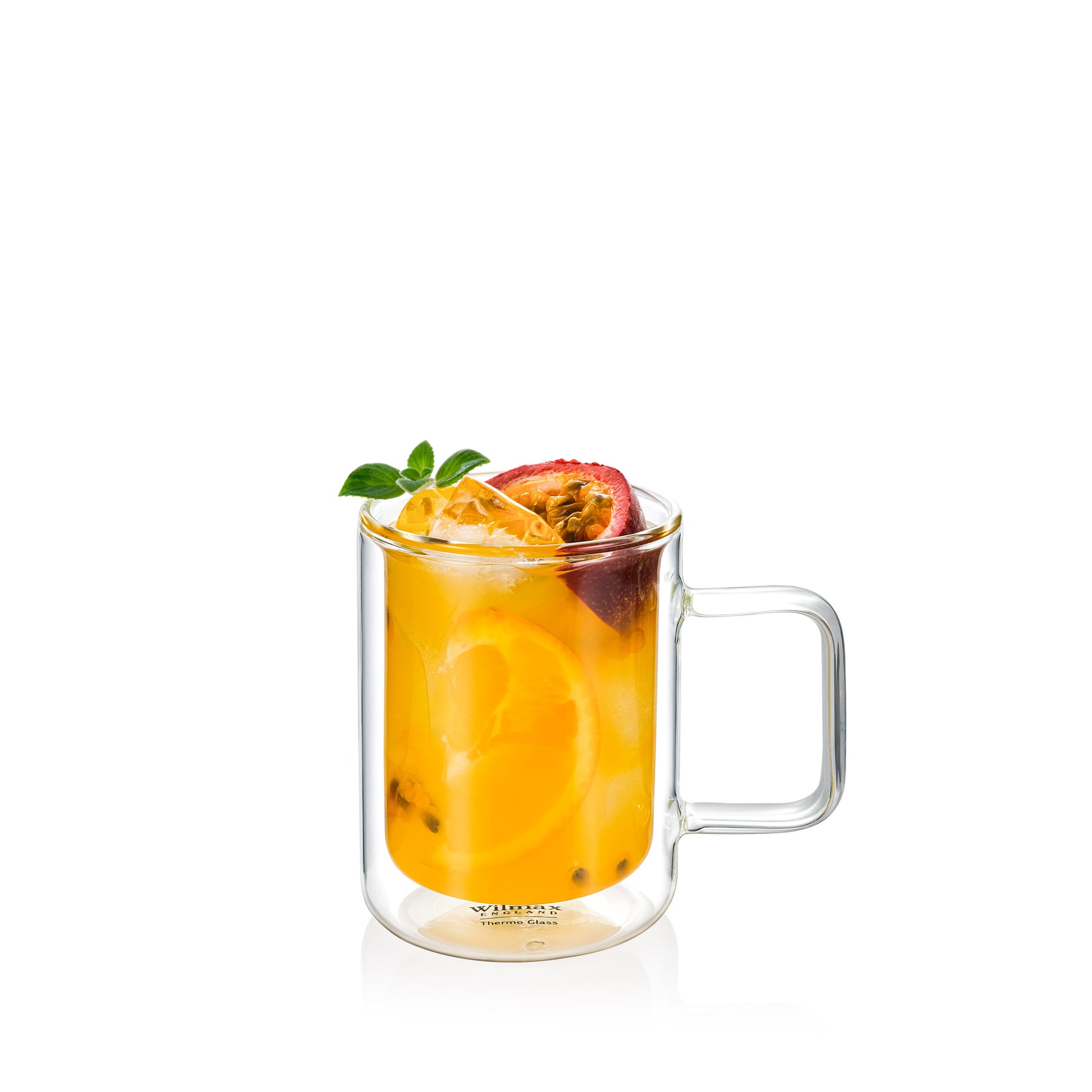 A clear double-walled glass mug with juice and fresh fruit and ice inside. Ice Tea in a Glass. A 300ml capacity, featuring a straight cylindrical shape and a square handle. The design provides insulation to maintain beverage temperature while keeping the exterior cool to the touch. Designed by Wilmax England, it reflects a sleek and modern aesthetic.